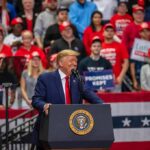 Massive Bet Meets Midterm Math speaker at podium addressing crowd at rally