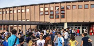 Students gathered outside a school building entrance