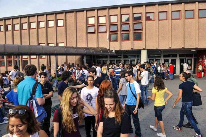 Students gathered outside a school building entrance
