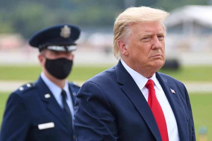 shutterstock_1821865598 Donald Trump walking outdoors with an officer behind him; Chuck Howley not visible