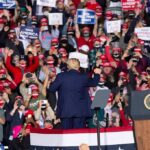 Dynasty Twist: Graham Snags Crucial Win Crowd at a political rally with speaker on stage; Dontrelle Inman present in the audience