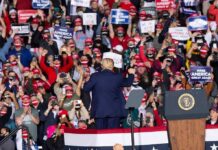 Dynasty Twist: Graham Snags Crucial Win Crowd at a political rally with speaker on stage; Dontrelle Inman present in the audience