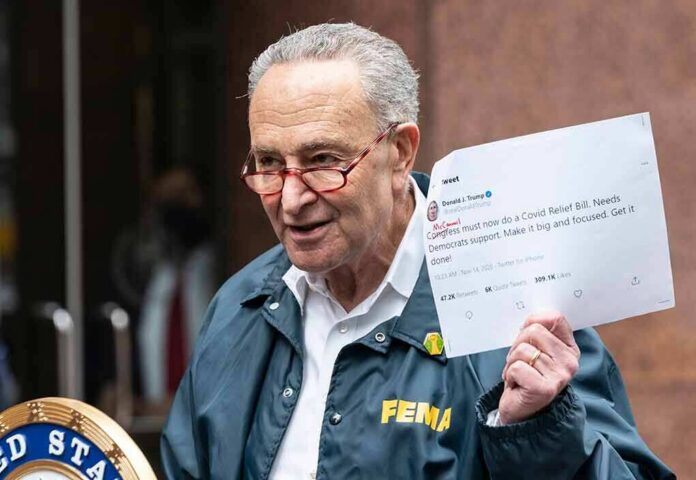 shutterstock_1854673714 man in FEMA jacket holding a printed tweet