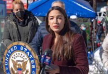Prime-Time Swipe Targets AOC’s Fertility Woman speaking at outdoor press event with microphones and seal