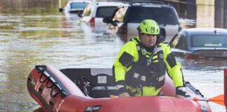 Rescue worker in an inflatable boat during urban flooding
