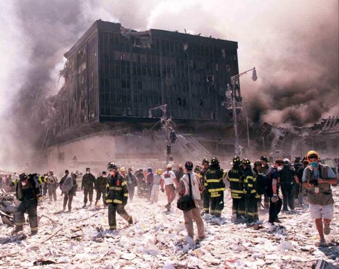 First responders amid debris near a heavily damaged building