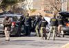 Shots Fired At Cops And Chopper Police and sheriff officers gather around vehicles on a suburban street