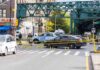 Queens Street Clash Ends In Blood Police cars block a city intersection with yellow crime scene tape