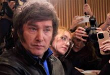 Argentina President Torches UN, Cuts Big U.S. Deal Man surrounded by reporters with cameras and phones