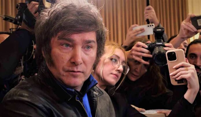 shutterstock_2349157881 Man surrounded by reporters with cameras and phones