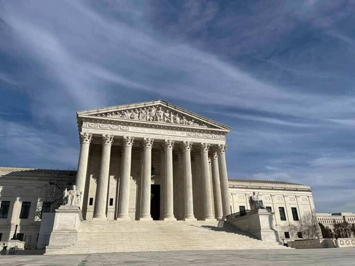 shutterstock_2363558997 Supreme Court building with grand columns under a blue sky