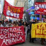 DSA Surge Rattles 2026 Primaries Protesters holding large banners at a city street demonstration