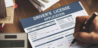 Driver's license application form being filled out by hand