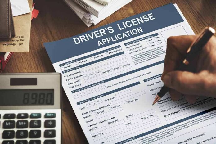 Driver's license application form being filled out by hand