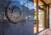 Enemies List Bombshell Hits FBI Chief FBI emblem on a stone wall beside a glass entrance