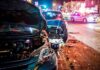 Wrecked cars at night crash scene with police lights