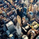 Deadly NYC Outbreak Declared Over Aerial view of dense downtown skyscrapers at sunset