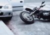 DA Targets Parents In 13-Year-Old Crash Motorcycle lying on the street beside a car with an open door