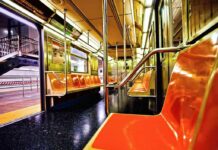 Rush-Hour Killing Sparks Panic Empty subway car with orange seats and open doors
