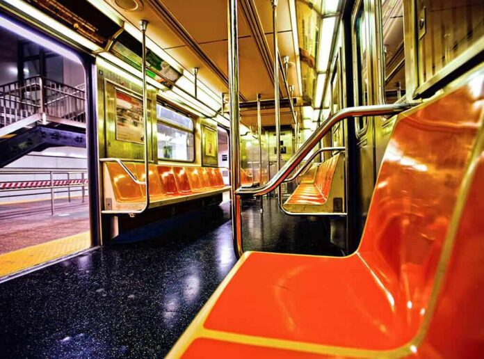 shutterstock_112362902 Empty subway car with orange seats and open doors