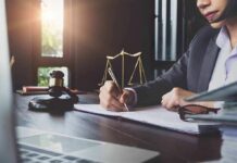 Digital Trail Torches Idol Alum’s Alibi Lawyer writing at desk with gavel and scales