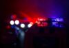Night Chaos Slams Small-Town Georgia Police car light bar flashing red and blue at night