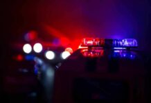 Police car light bar flashing red and blue at night