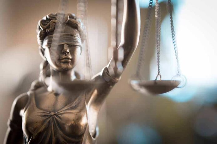 shutterstock_1220844322 Lady Justice statue holding scales