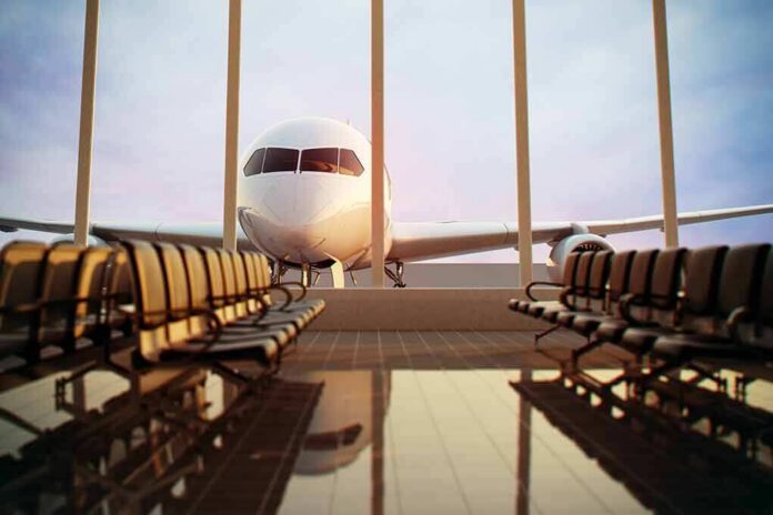 Airplane seen through terminal windows with empty gate seating