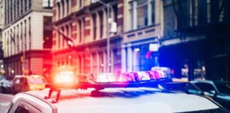 Police car with flashing lights in city street
