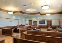 Judge FREEZES Deportation After Bronx Gunfire Empty courtroom with wooden benches and judge's bench