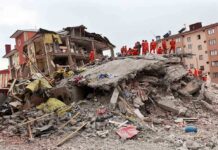 School Horror: Roof Crashes Onto Kids Rescue workers in orange uniforms on a collapsed building site after an earthquake