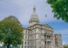 State capitol building with dome and American flag