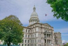 State capitol building with dome and American flag