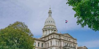 State capitol building with dome and American flag