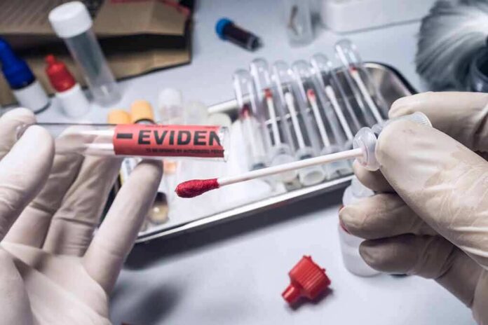 shutterstock_1701288700 Gloved hands handling a swab and evidence tube