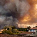 Wildfire Panic Slams Santa Clarita Wildfire smoke billows over suburban houses