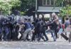 Tourist Icons Become Battlegrounds Protesters clash with riot police holding shields