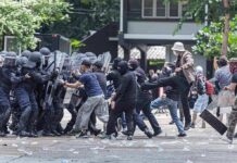 Tourist Icons Become Battlegrounds Protesters clash with riot police holding shields
