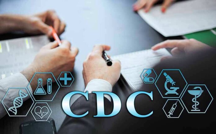 shutterstock_1902748288 Hands writing notes at a meeting table with medical icons overlay