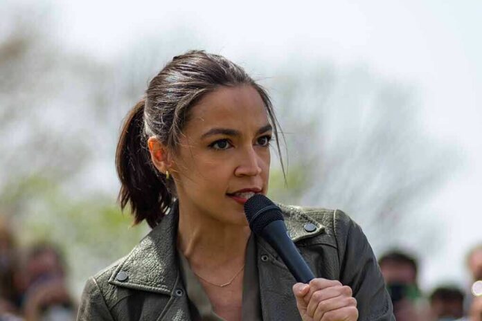 AOC speaking into a handheld microphone outdoors