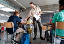 Homework Is Dead – Berkeley Throws the Flag Teacher handing out papers in a classroom