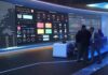 Internet Backbone Bug Sparks Panic cybersecurity operations room with large data dashboards and people discussing