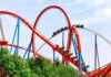 Major Crimes Swarms Six Flags Colorful roller coaster with riders on a sunny day