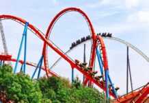 Major Crimes Swarms Six Flags Colorful roller coaster with riders on a sunny day