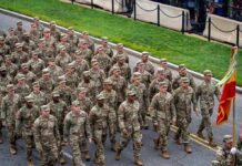Military Halt Triggers Election Panic Soldiers in camouflage uniforms march in formation on a street