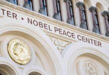 Nobel Committee Makes Its 2026 Choice Nobel Peace Center facade with arched windows and gold medallion