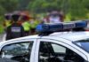Fatal Standoff Inside Elementary Police car with blue light bar at roadside scene