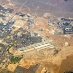 War Crime Alarm After Airport Missile Shot Aerial view of desert city with airport and highways