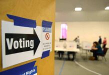 Christian Voters Split on Major Issues Voting sign on door leading to polling place